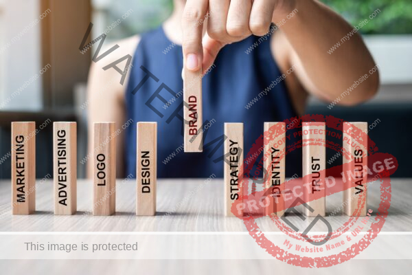 Businesswoman hand placing wooden Dominoes with text