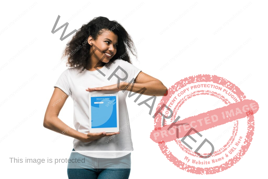 KYIV, UKRAINE - MAY 29, 2019: happy african american girl holding digital tablet with twitter app on