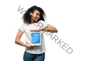 KYIV, UKRAINE - MAY 29, 2019: happy african american girl holding digital tablet with twitter app on