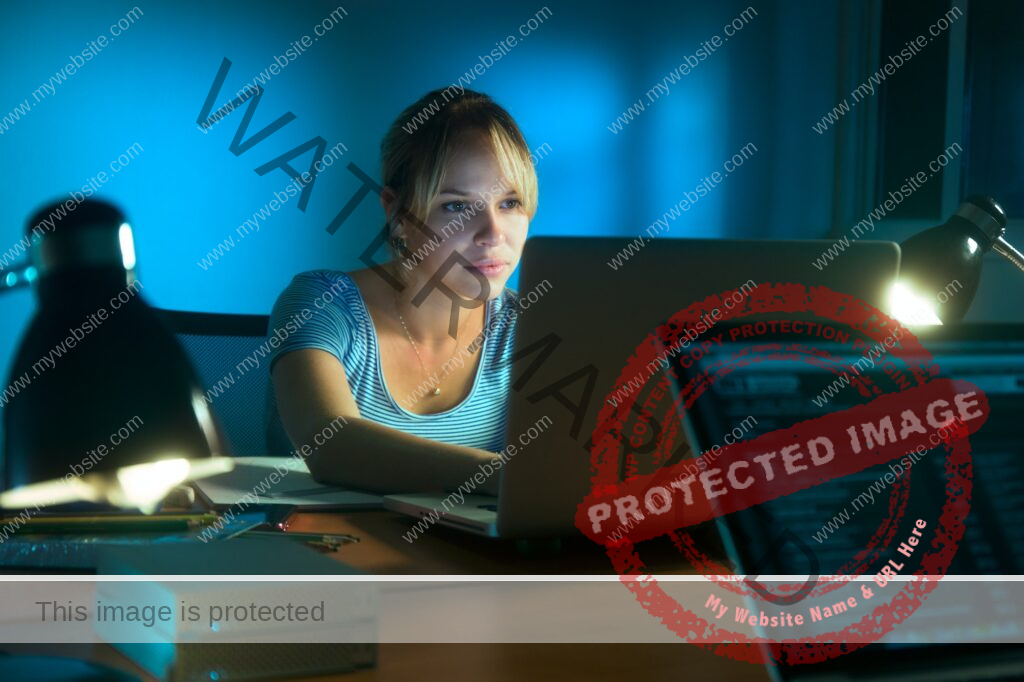 Woman Writing On Laptop Computer Late At Night